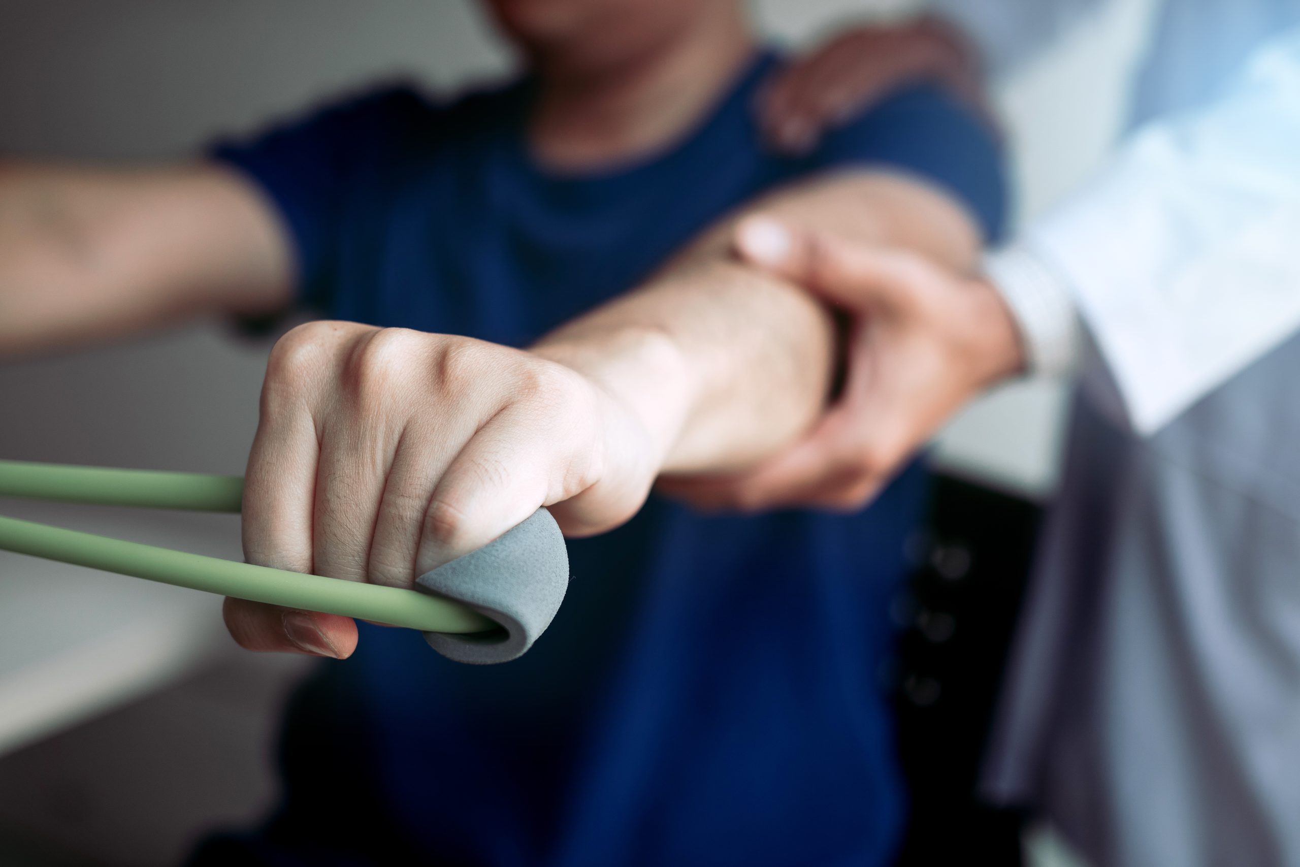 Asian male physical therapist descent working with patient doing